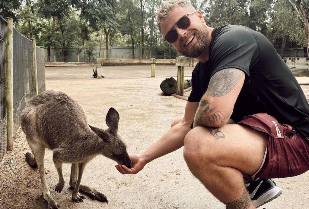 Chris feeding a joey