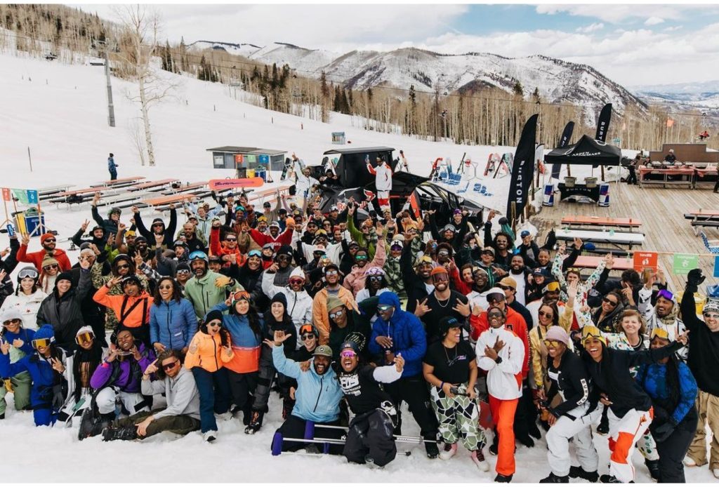 Kenny in a large group at a snowboarding event